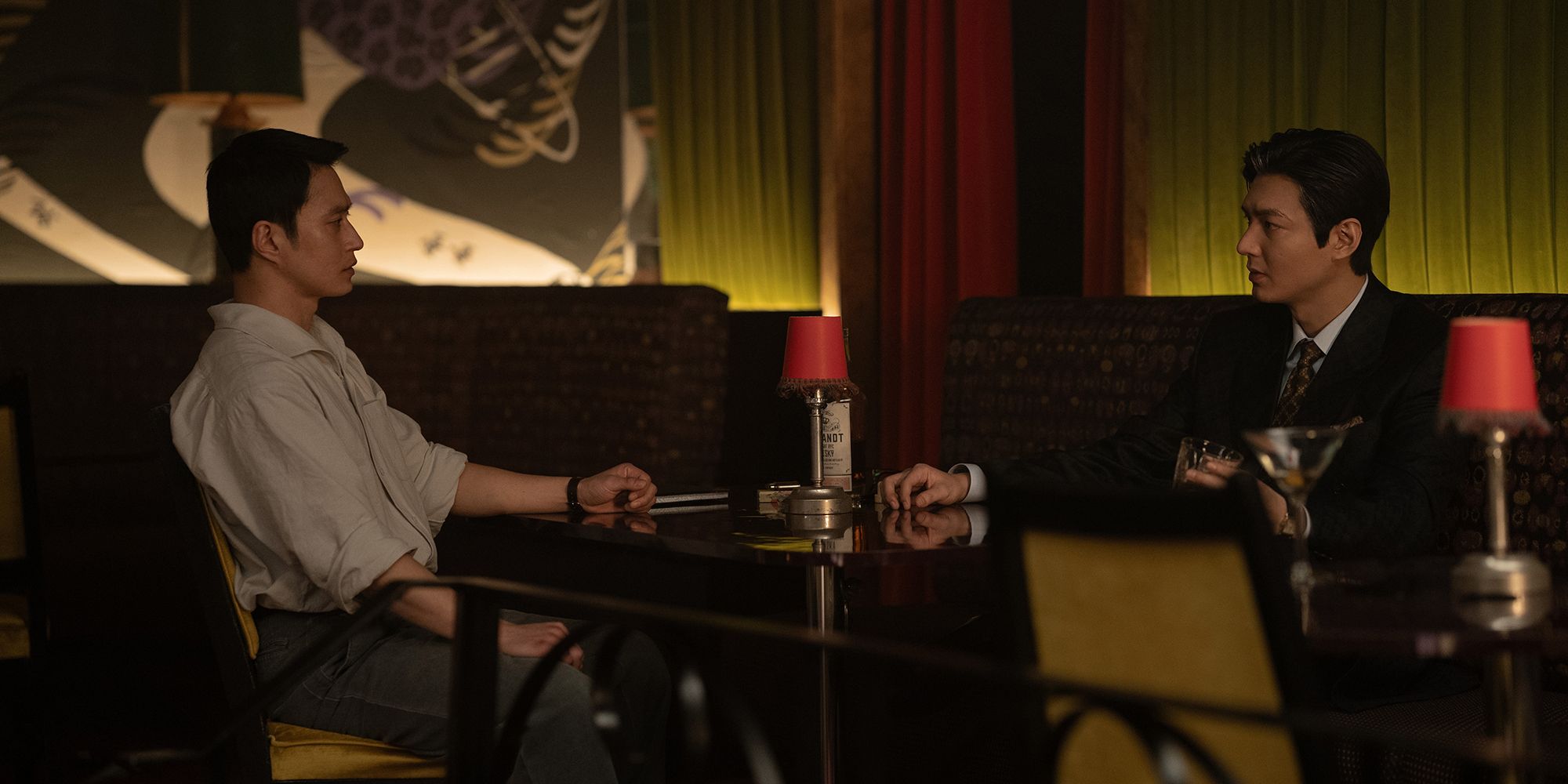 Sungkyu Kim & Lee Minho sitting at a table in Pachinko season 2