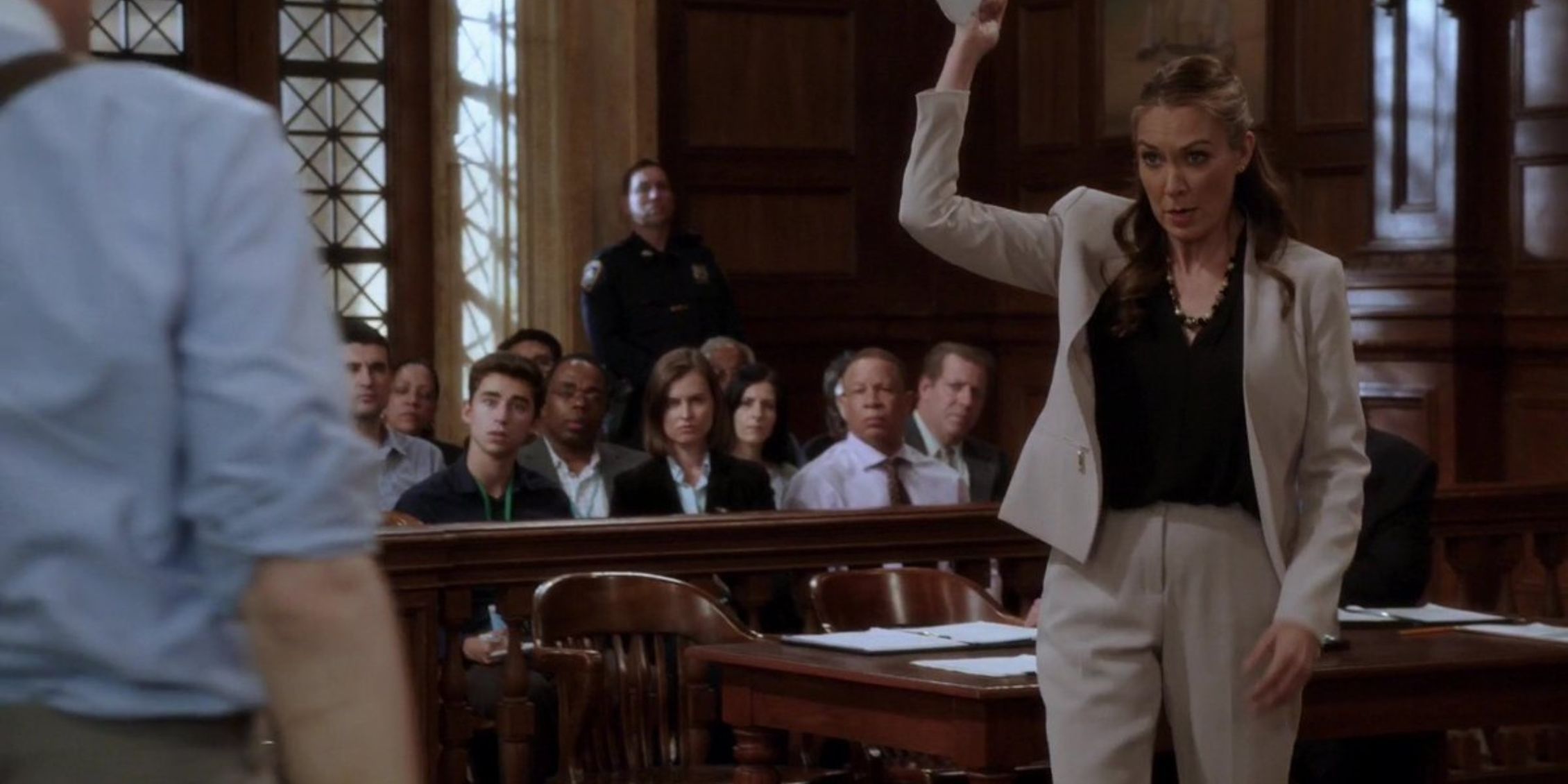 SVU Rita Calhoun holding a paper above her head while making a point in court