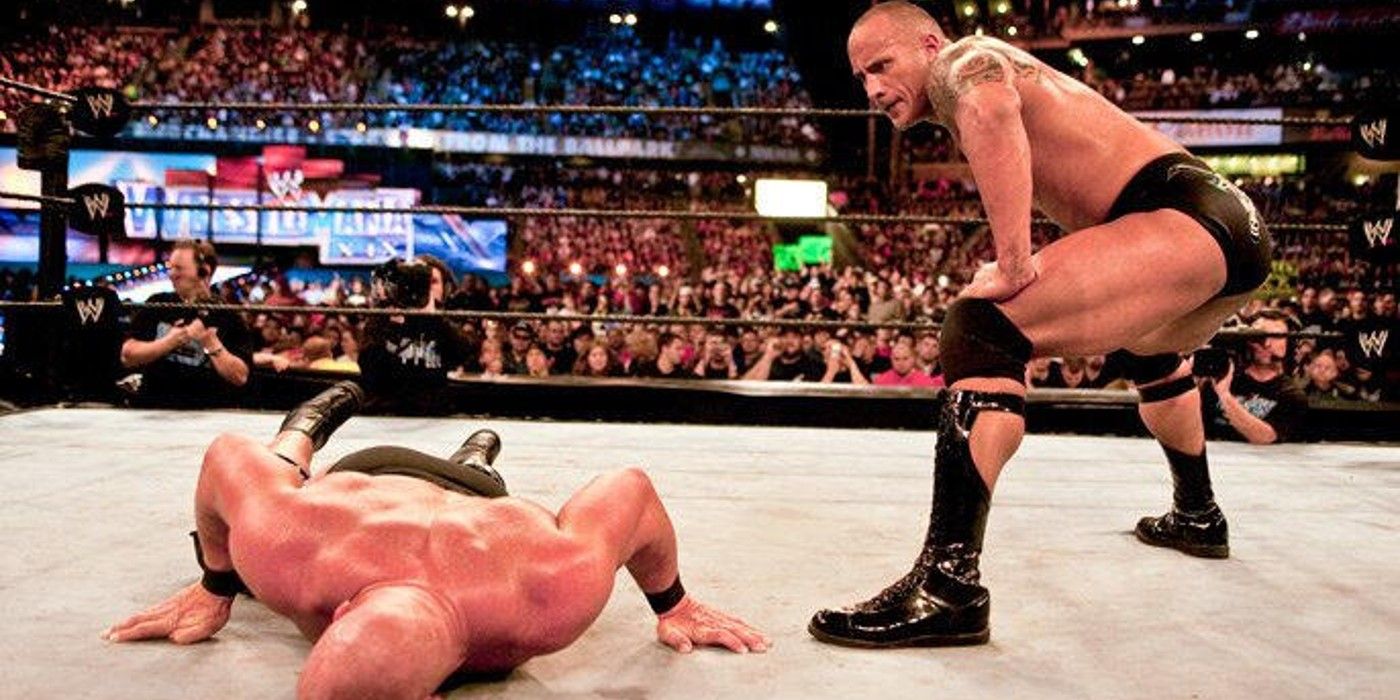 The Rock waits for Stone Cold Steve Austin to get up at WWE WrestleMania 19