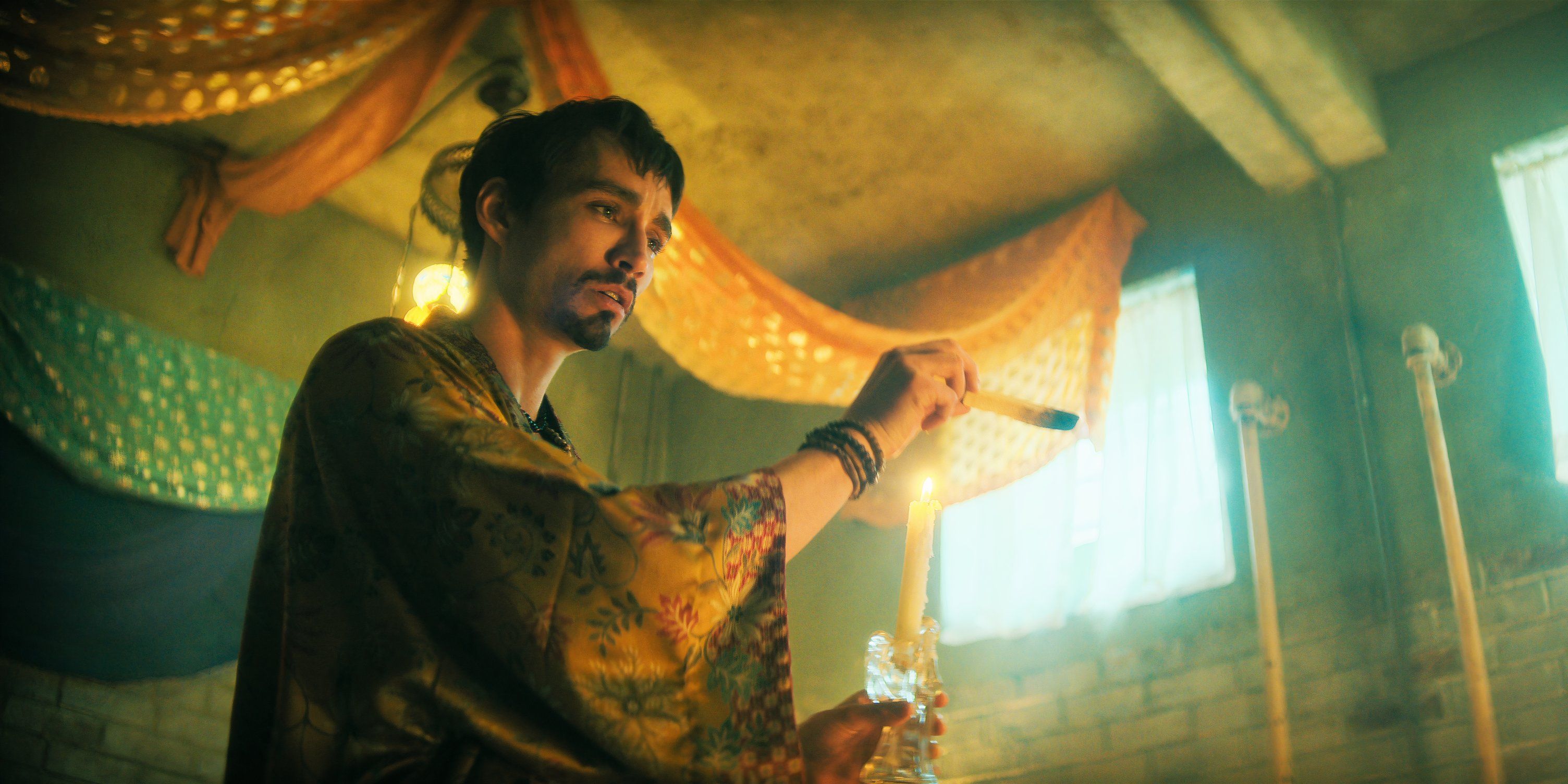 Robert Sheehan as Klaus Hargreeves spreading sage in The Umbrella Academy season 4.