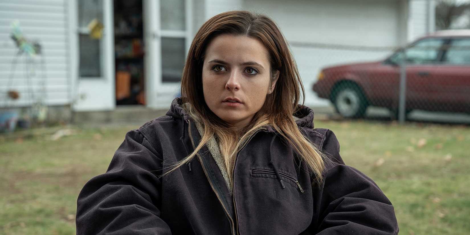 Maggie (Gabrielle Creevy) looking annoyed, sitting in her yard in Three Women.