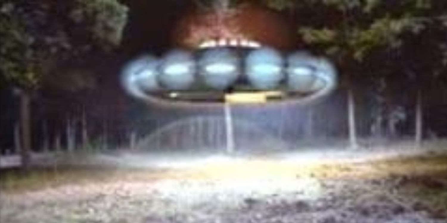 A still from Unsolved Mysteries. An image of a UFO in a forest.