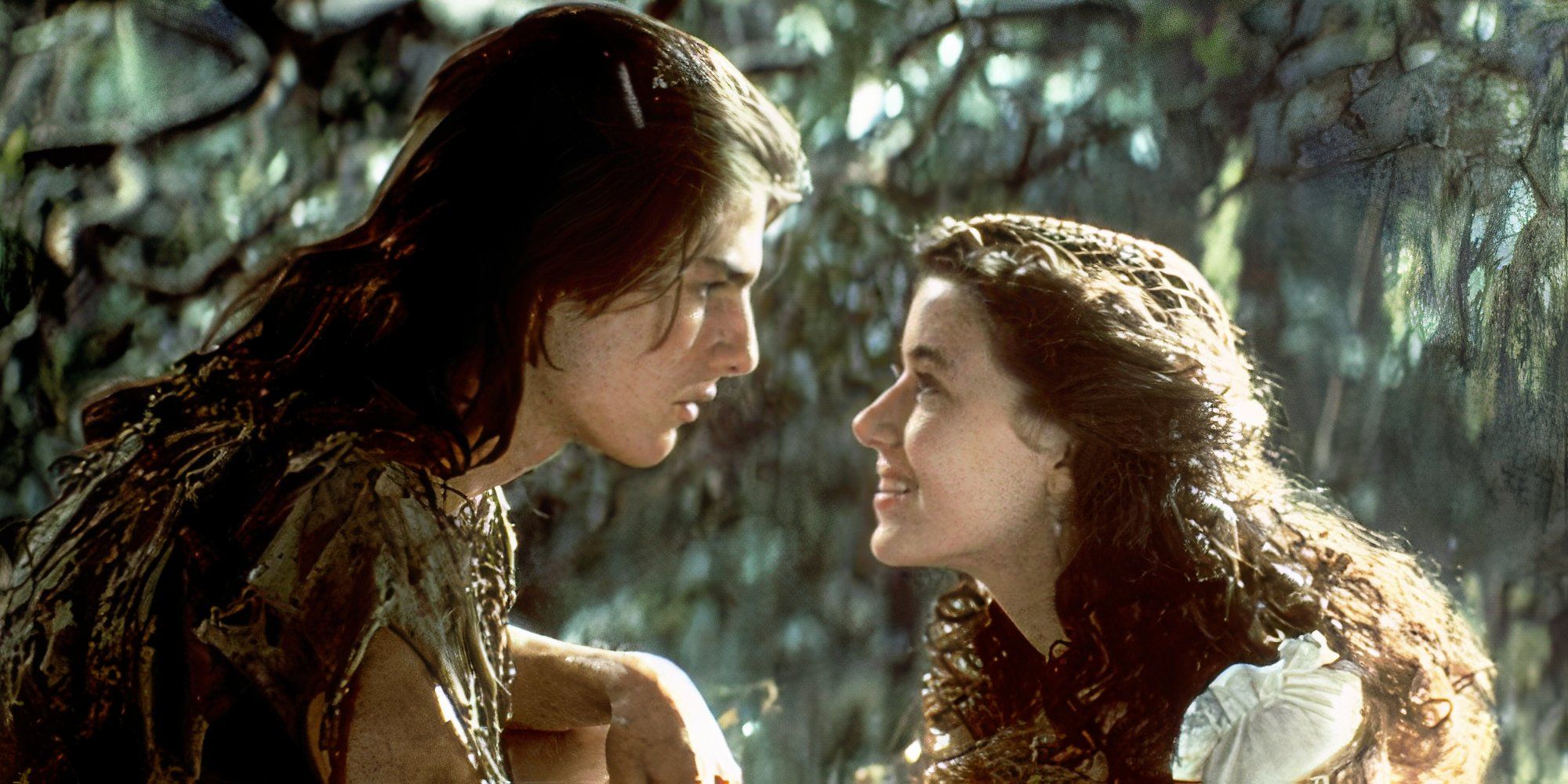 Mia Sara as Lili and Tom Cruise as Jack looking at each other intently in Legend