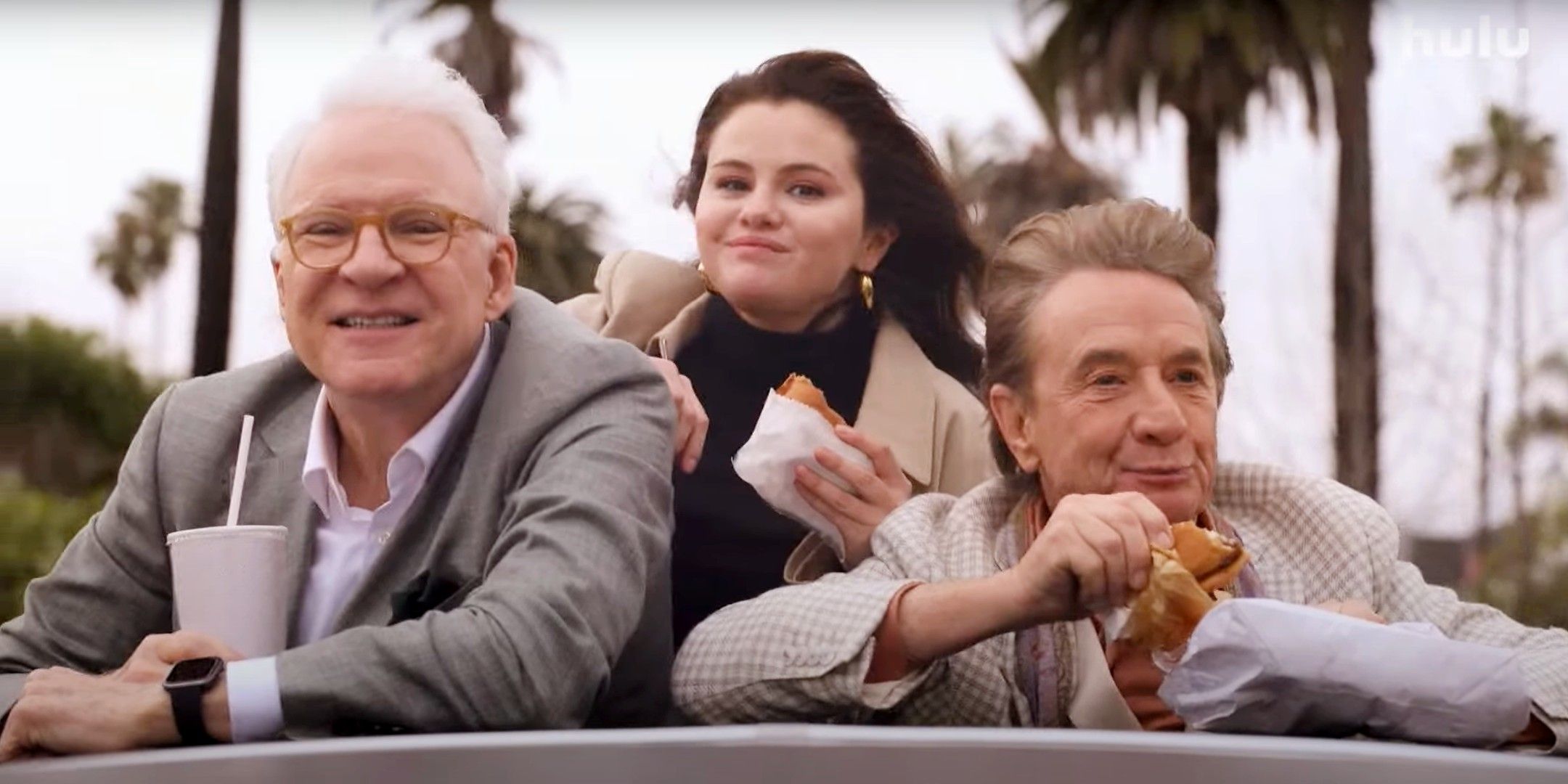 Steve Martin, Martin Short, and Selena Gomez standing up in the sunroof of a car in Only Murders in the Building season 4