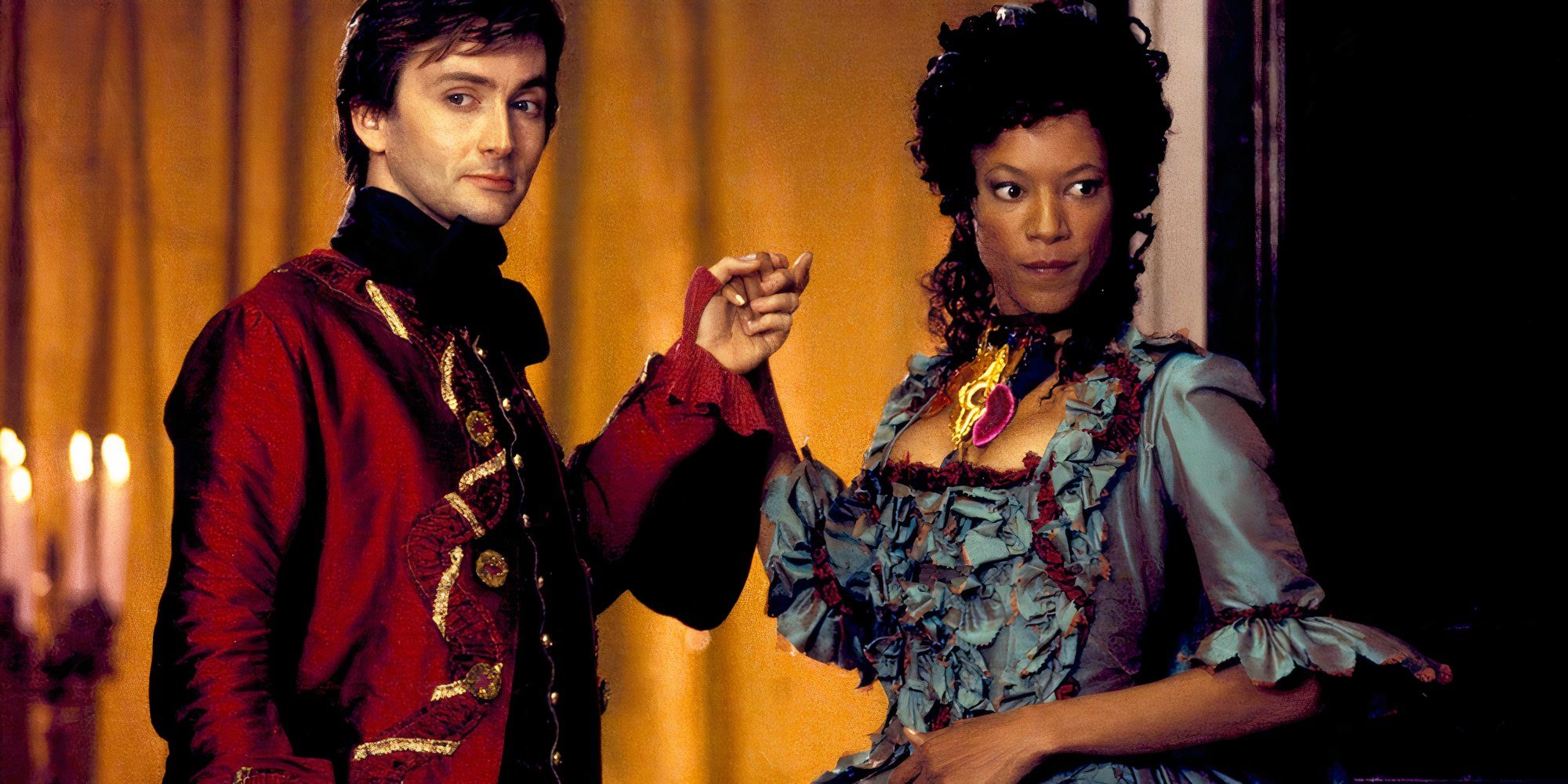 David Tennant as Giacomo Casanova and Nina Sosanya as Bellino holding hands and smirking in Casanova.