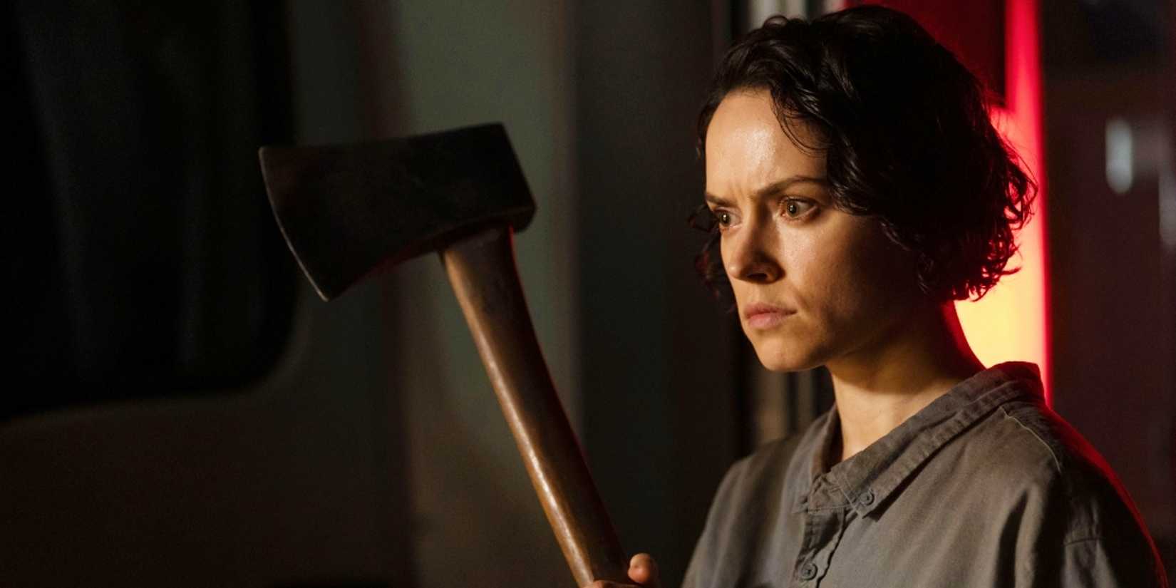 Daisy Ridley holding an ax in We Bury the Dead