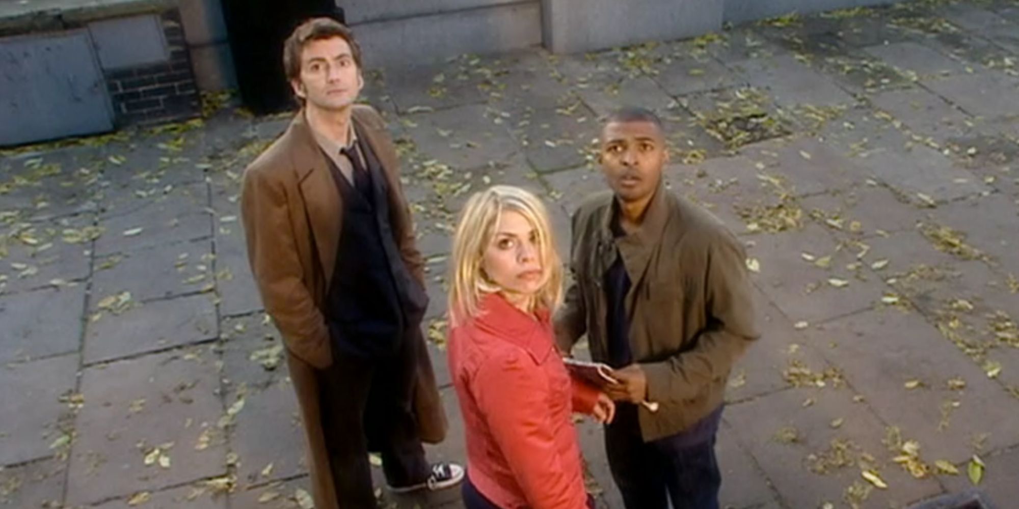 The Doctor, Rose, and Mickey all looking to the sky in Doctor Who