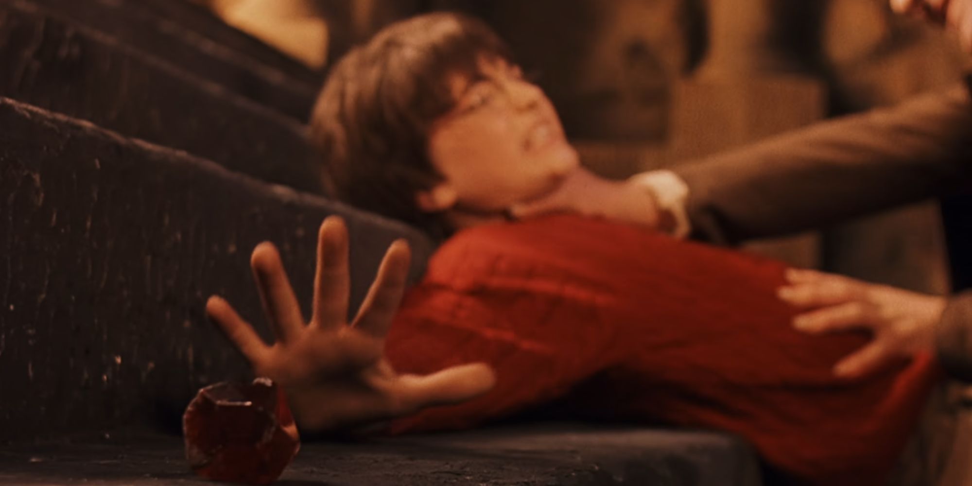 Daniel Radcliffe is strangled as Harry Potter when he reaches for the Philosopher's Stone