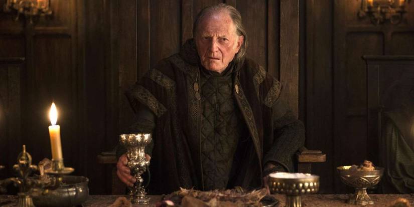 Walder Frey standing at a table before a feast in Game of Thrones