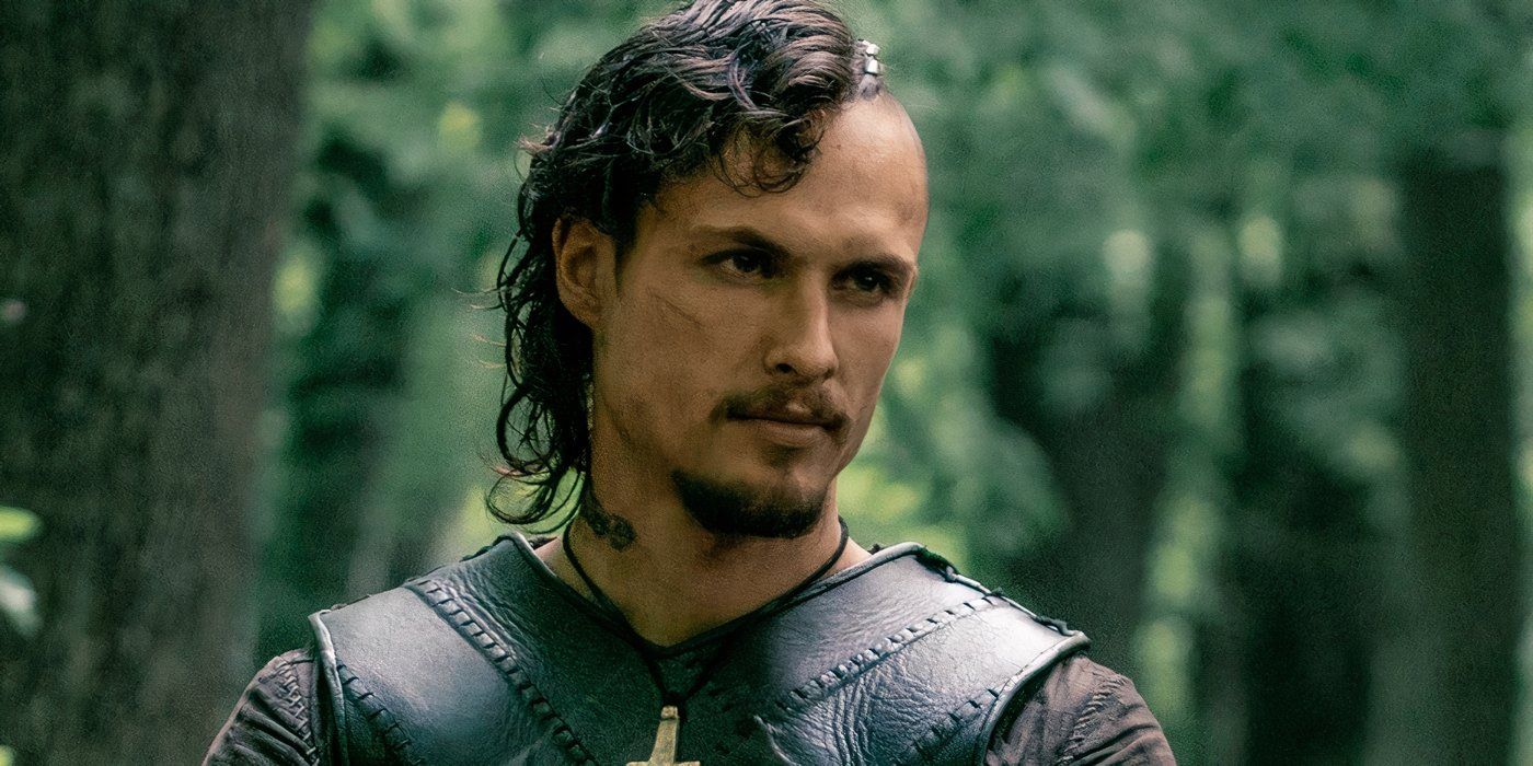  Arnas Fedaravičius smirks blankly while standing in the woods in the Last Kingdom