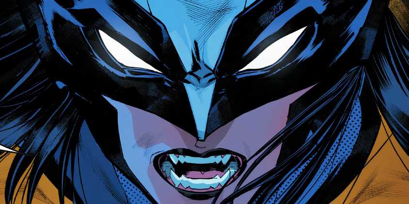 Close up of Laura Kinney as Wolverine, bearing her sharp teeth beneath her masked eyes.
