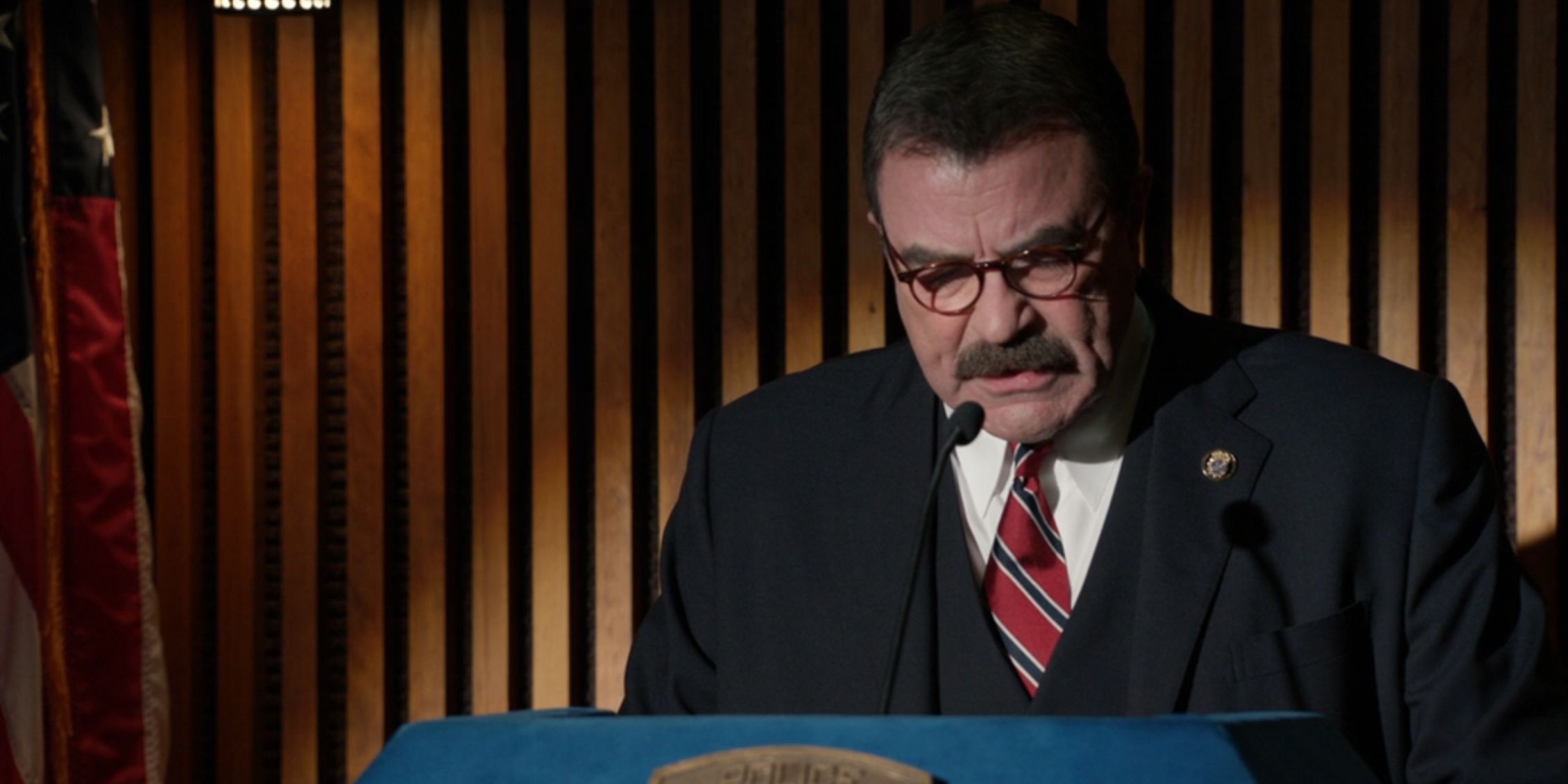 Blue Bloods Frank behind a podium delivering a speech