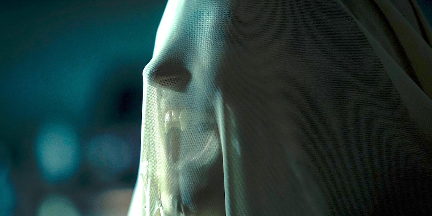 A female vampire under a shroud shows her teeth in Salem's Lot 2024