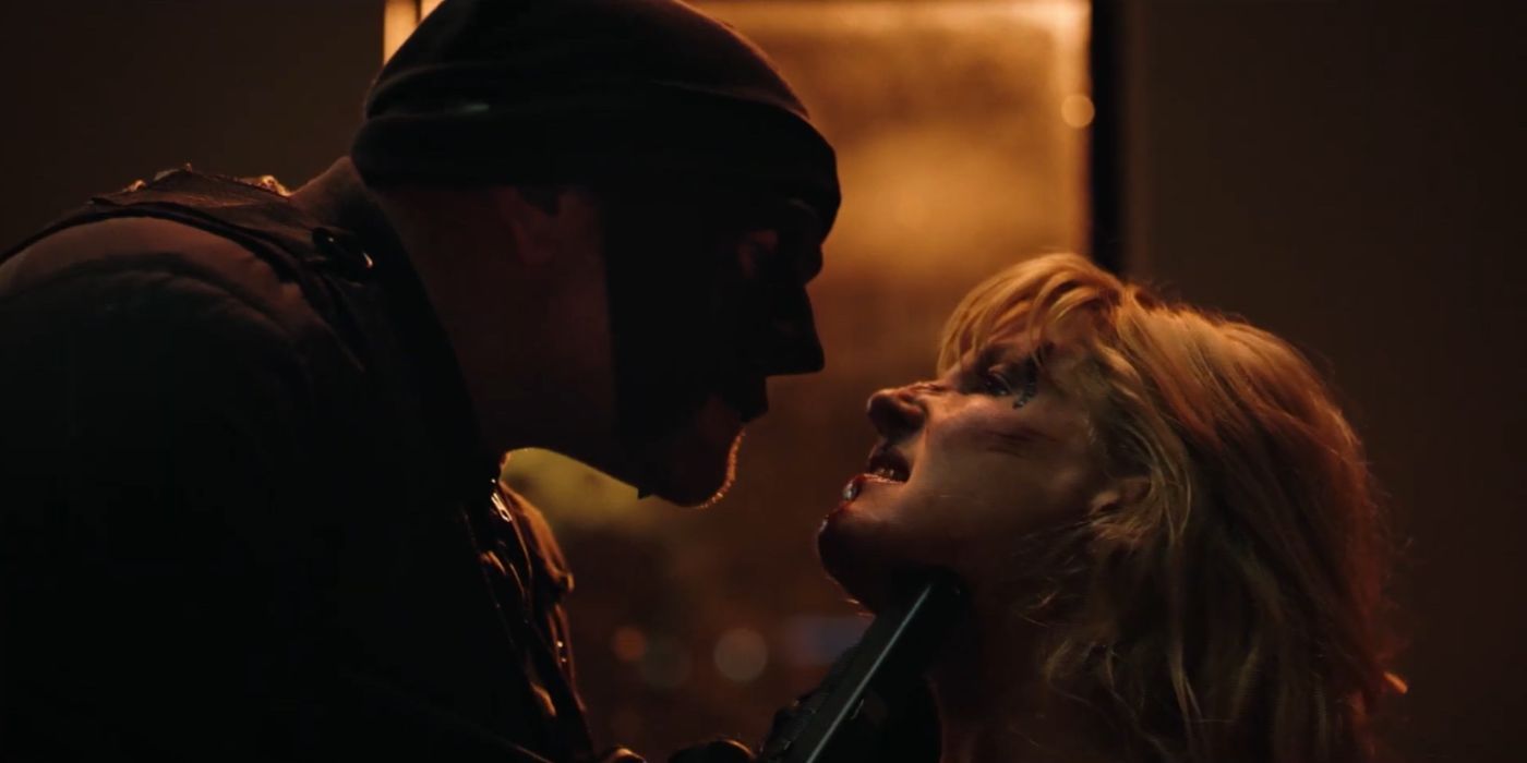 A masked man choking Beth (Kelly Reilly) in Yellowstone.