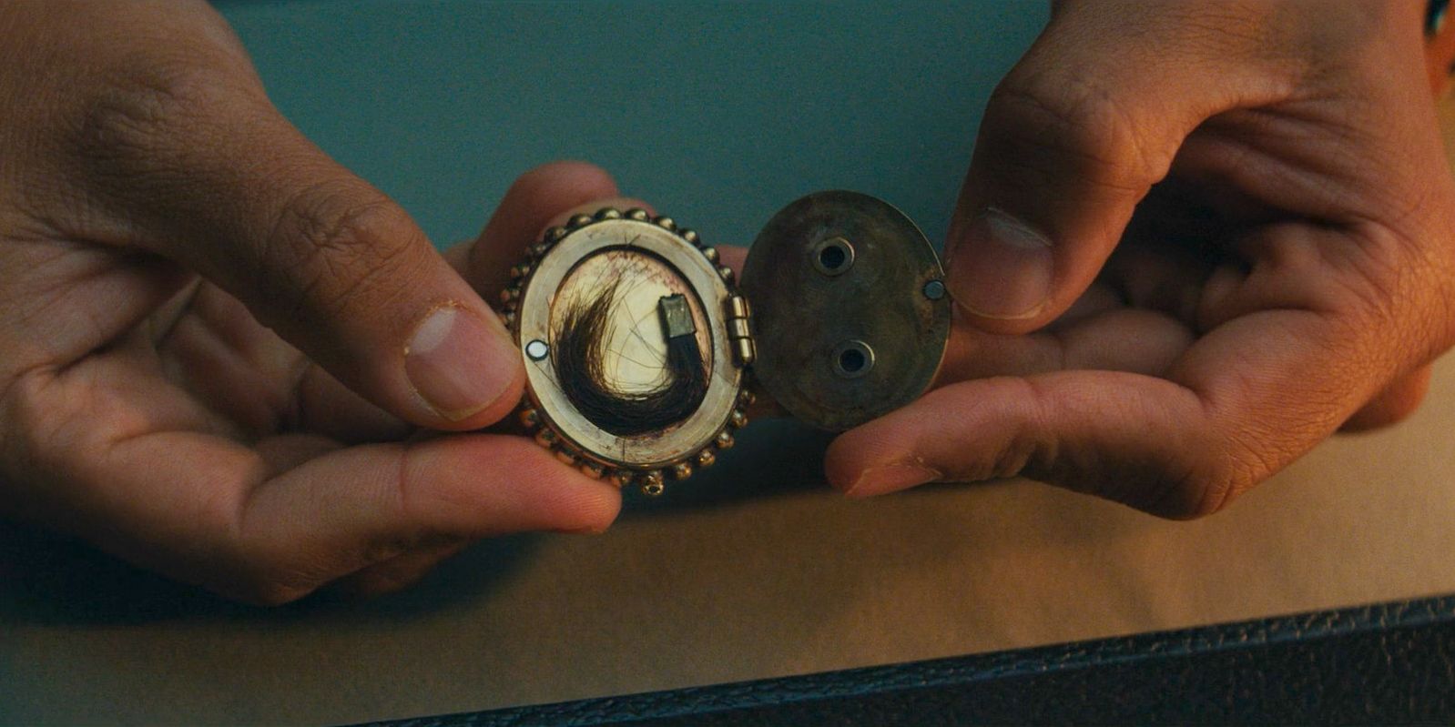 Agnes discovers that the brooch she found is a locket in Agatha All Along Season 1 Episode 1