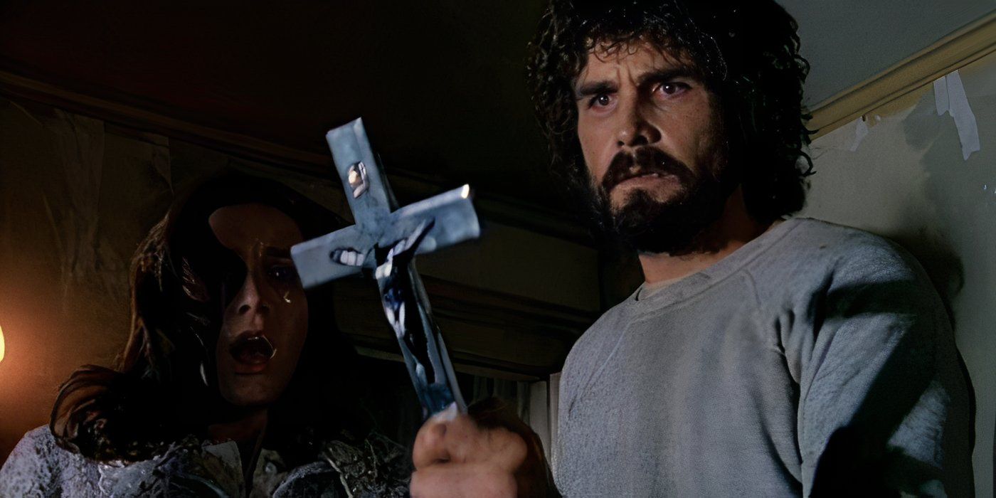 Lutz holding a cross in The Amityville Horror