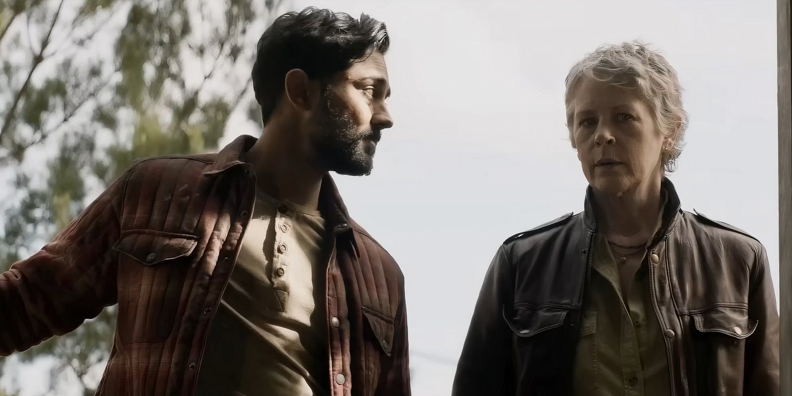 Ash (Manish Dayal) opens something while looking at Carol (Melissa McBride) in The Walking Dead: Daryl Dixon Season 2 trailer 