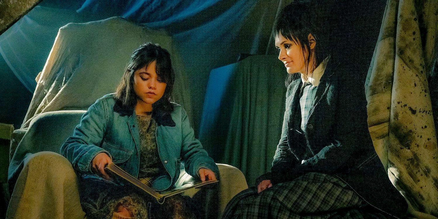 Jenna Ortega as Astrid and Winona Ryder as Lydia in the attic, looking at an old photo album in Beetlejuice Beetlejuice