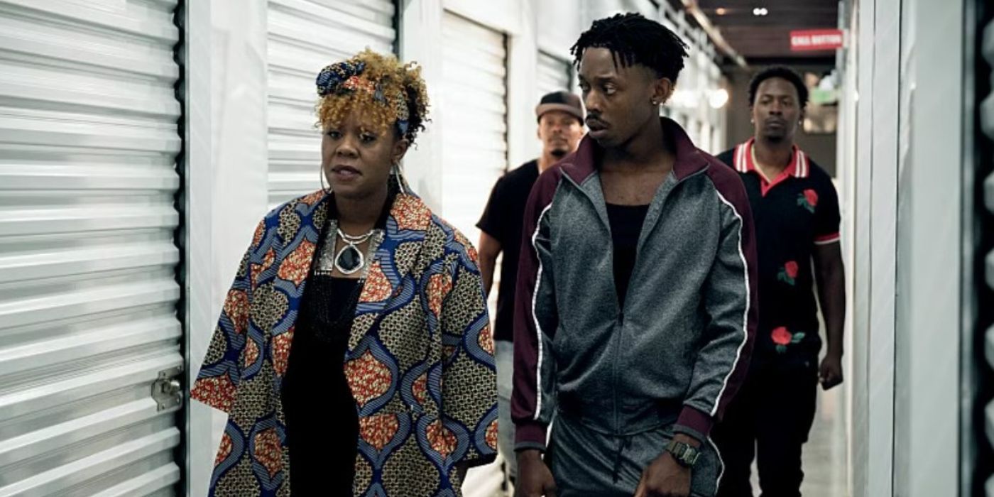 Big Mo (Andrene Ward-Hammond) and Little Mo (Keith Machekanyanga) walking together through storage lockers in Your Honor.