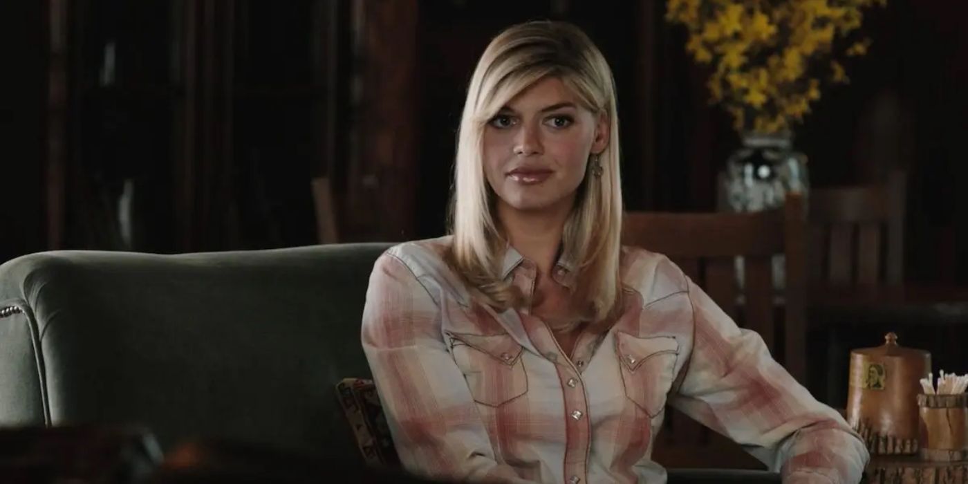 Cassidy Reid (Kelly Rohrbach) sitting on a couch thinkgin about something in Yellowstone. copy