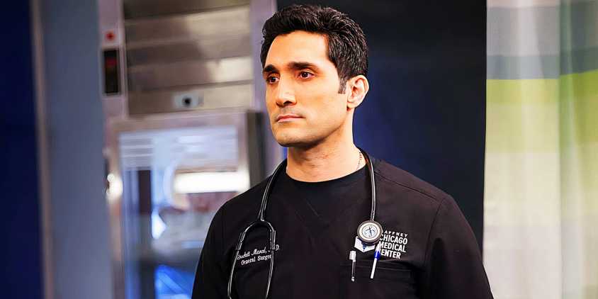 Marcel standing with his stethoscope around his neck and a serious look on his face in Chicago Med