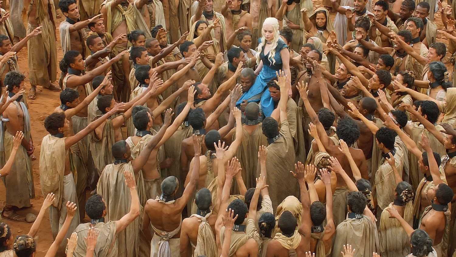 Daenerys (Emilia Clarke) wearing a blue dress, walking among a crowd of people from Yunkai in Game of Thrones season 3's finale