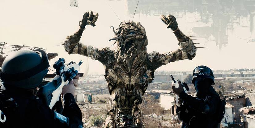 District 9 alien being arrested by people with guns.