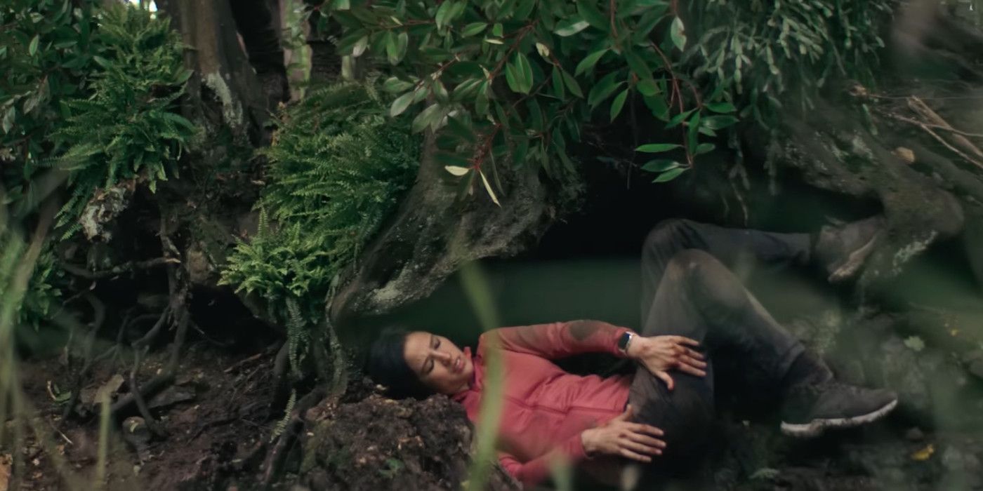 Kelsey Asbille sitting on the forest floor struggling in Don't Move