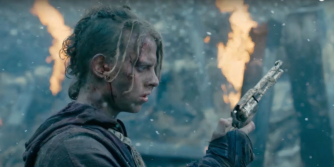 Eli finds a gun in the wreckage of Into The Badlands, as a fire burns in the background.