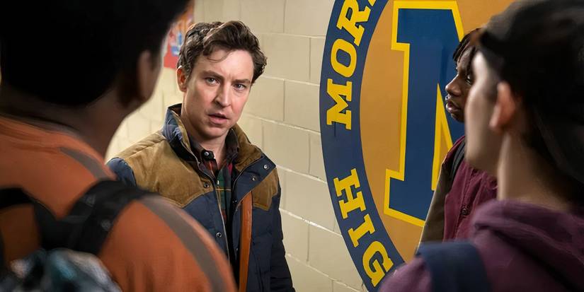 Evan listens with an angry look as three students talks to him in the school hallway in English Teacher