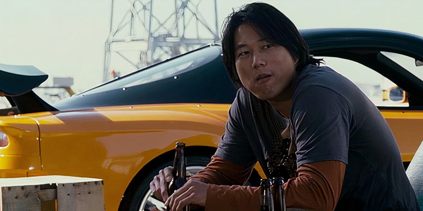 Han sitting by his drift car in the Fast and Furious movie Tokyo Drift. 