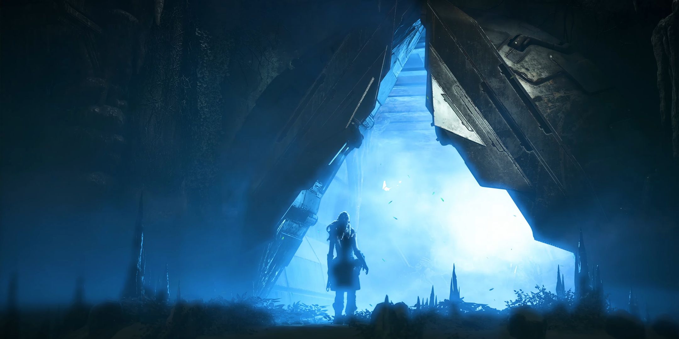 Horizon Zero Dawn Aloy se encuentra frente a un triángulo de luz azul dentro de un entorno tecnológico.