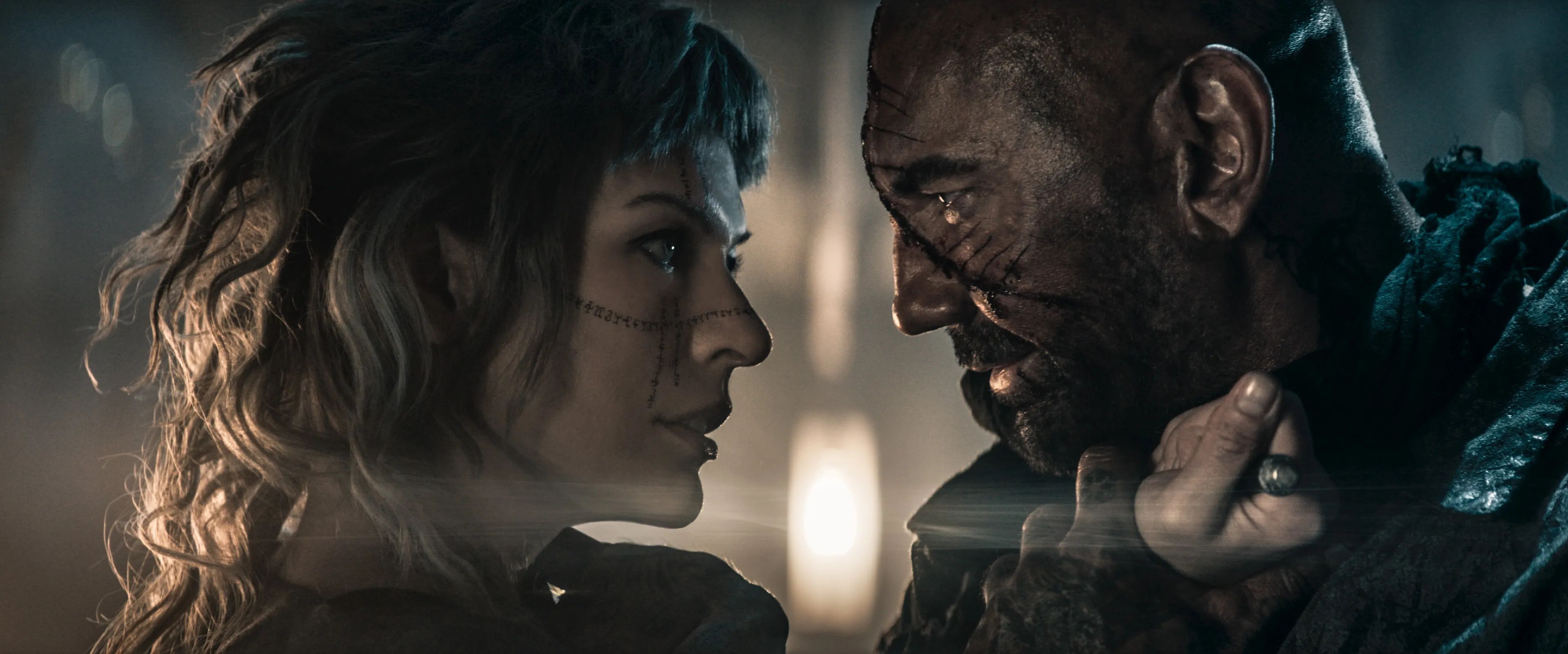 Milla Jovovich as Alice Gray and Dave Bautista as Boyce in The Lost Lands