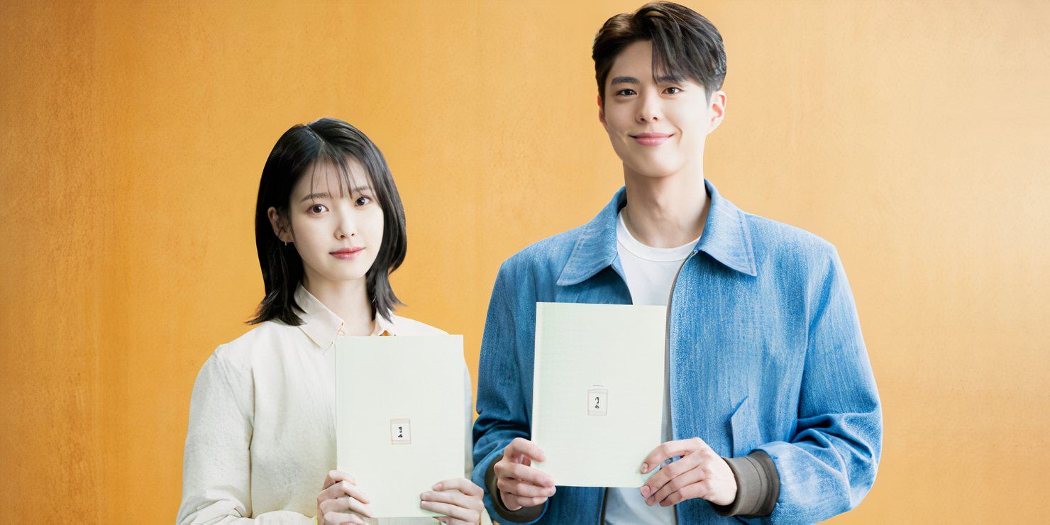 IU and Park Bo-gum holding sheets of paper as they stand against an orange background in a promotional image announcing their casting for When Life Gives You Tangerines