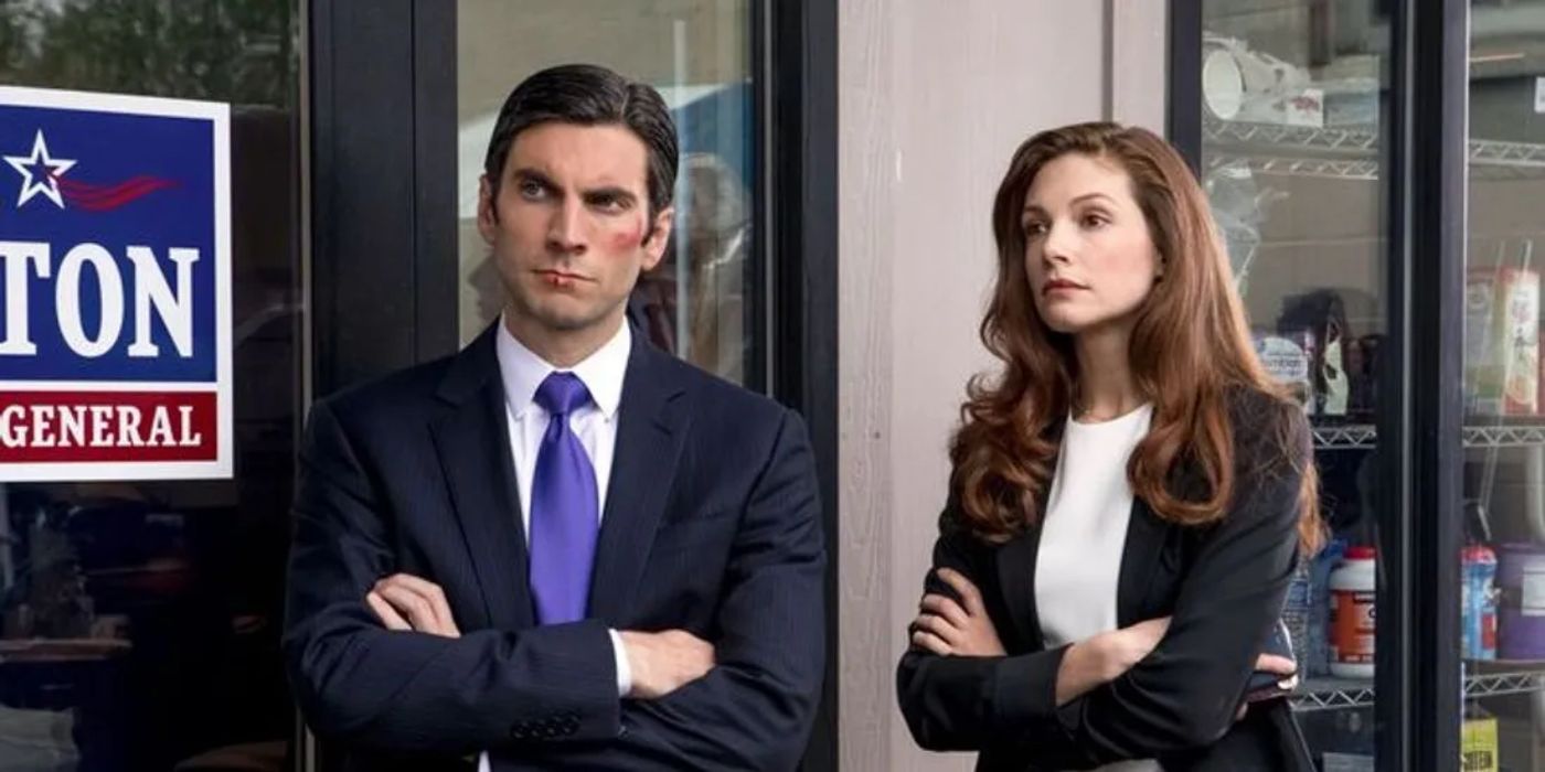 Jamie Dutton (Wes Bentley) and Christina (Katherine Cunningham) standing together outside Jamie's office in Yellowstone.