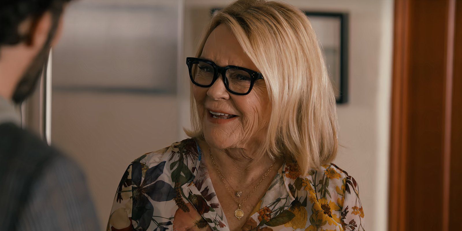 Joanne's mom smiles while talking to Noah in Nobody Wants This episode 6