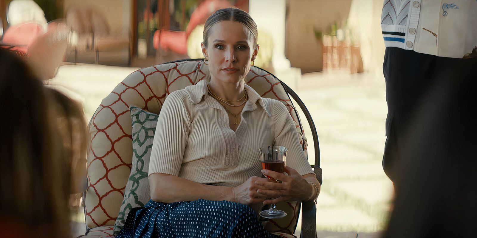 Joanne sits outside holding a wine glass in Nobody Wants This episode 9