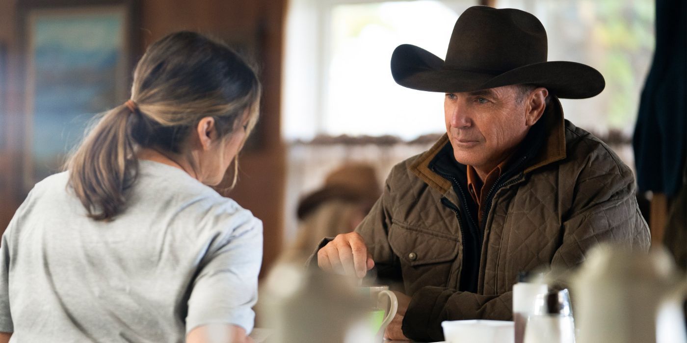 John Dutton (Kevin Costner) smiling at a woman at a diner in Yellowstone.