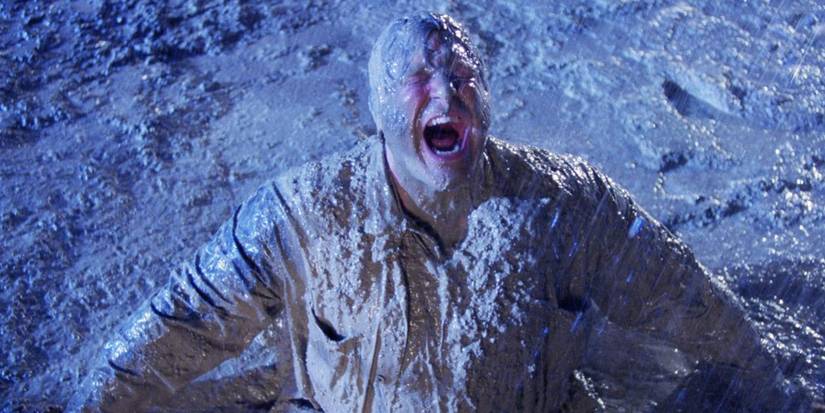 John Goodman covered in mud and screaming with rage in Raising Arizona