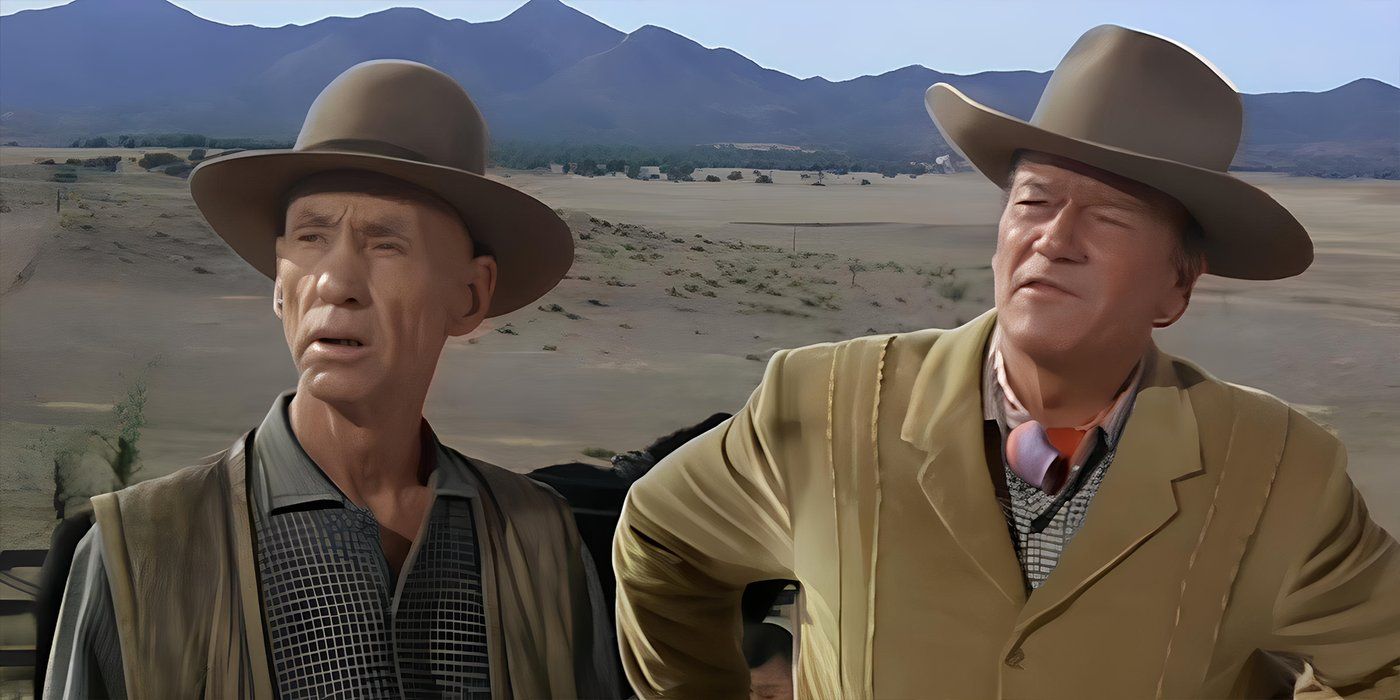 John Wayne e Hank Worden ambos em roupas de cowboy em um faroeste