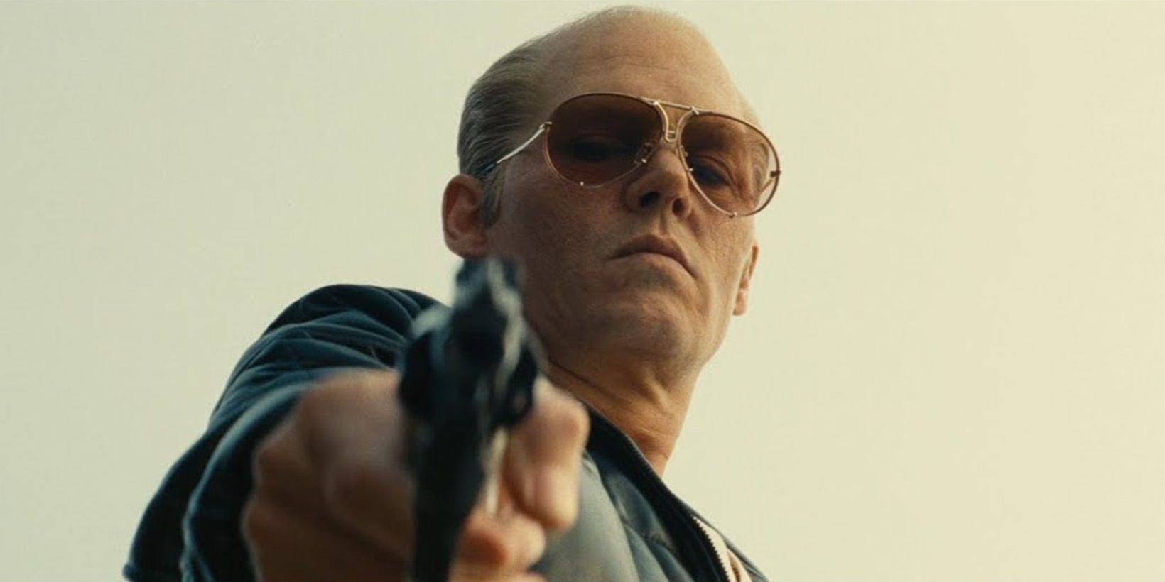 Johnny Depp with a gun in Black Mass