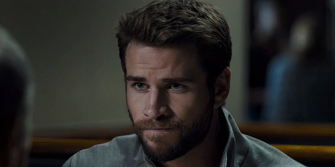 Liam Hemsworth as Dodge sitting at a table in Most Dangerous Game