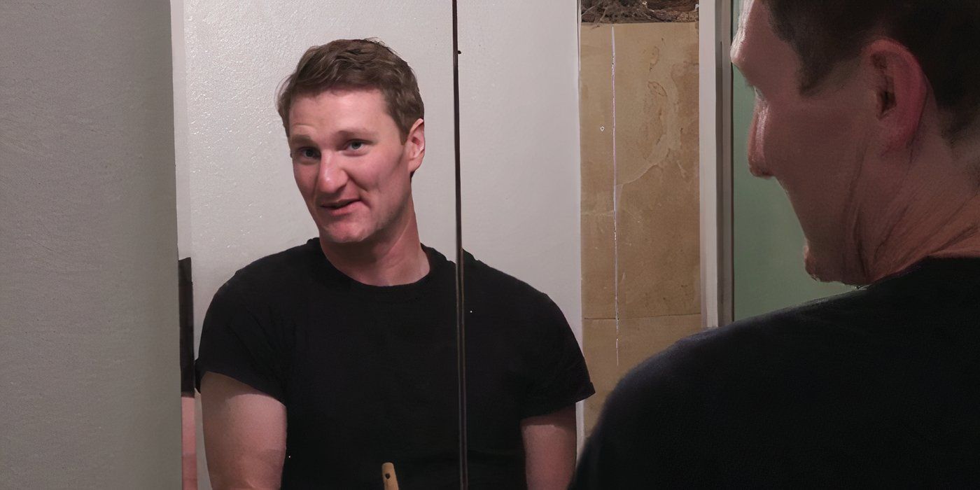 Loren Allen in 90 Day Fiance in black shirt smiling in mirror