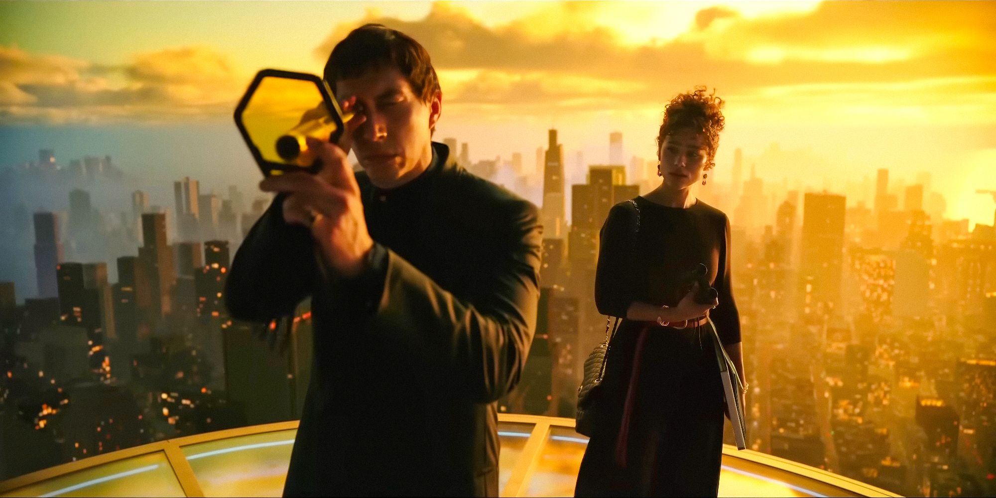 Cesar Catilina (Adam Driver) and Julia Cicero (Nathalie Emmanuel) on top of a building with the city in the background in Megalopolis (2024)