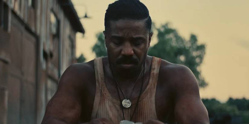Michael B. Jordan bloodied and looking upset in Sinners
