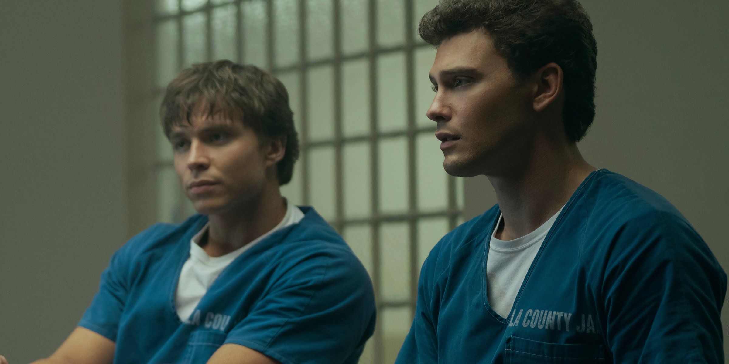 Lyle and Erik Menendez sit in blue jail clothes in Monsters: The Lyle and Erik Menendez Story.