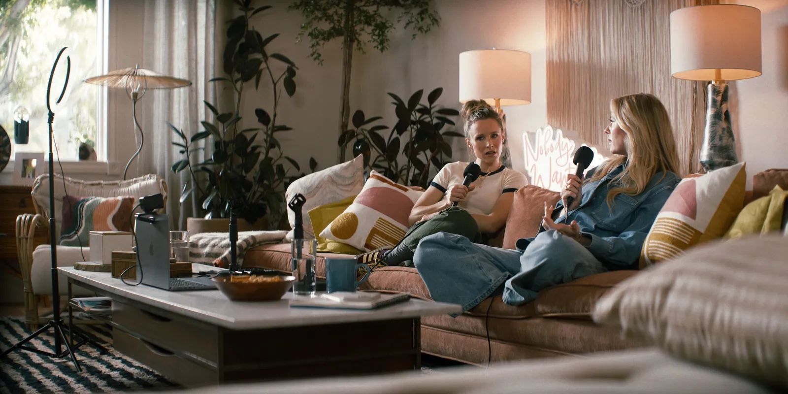 Kristen Bell and Justin Lupe on the couch in Nobody Wants This