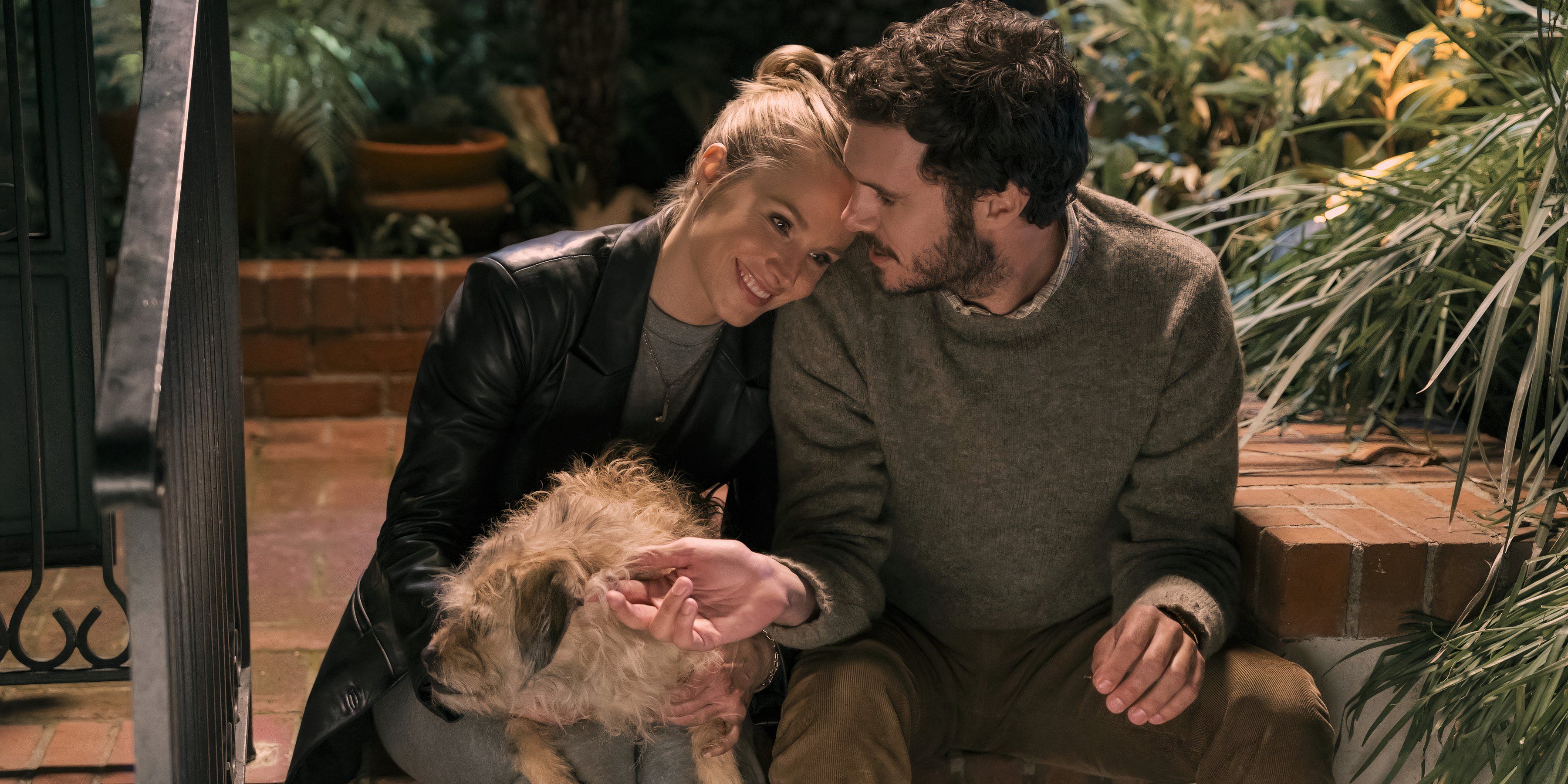 Joanne lays her head on Noah's shoulder while holding a dog on her lap in Netflix's Nobody Wants This.