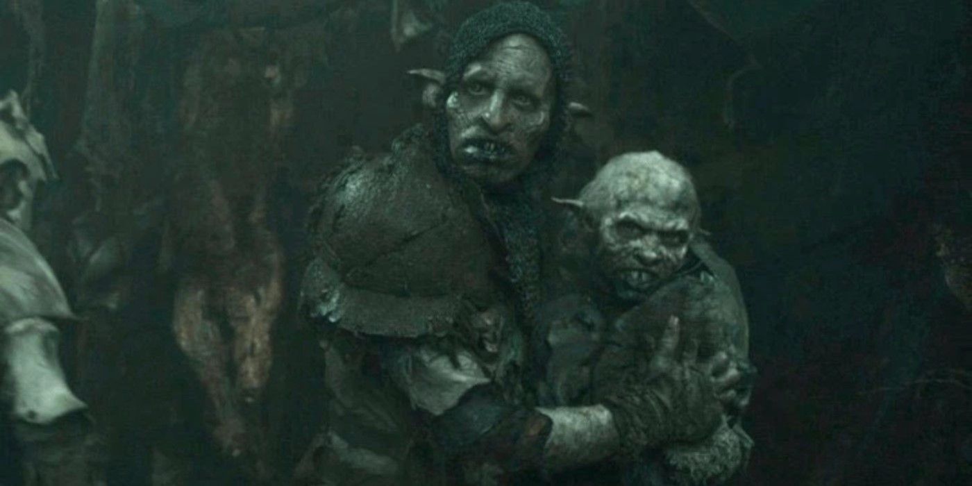 An Orc holding onto a baby Orc in The Rings of Power season 2