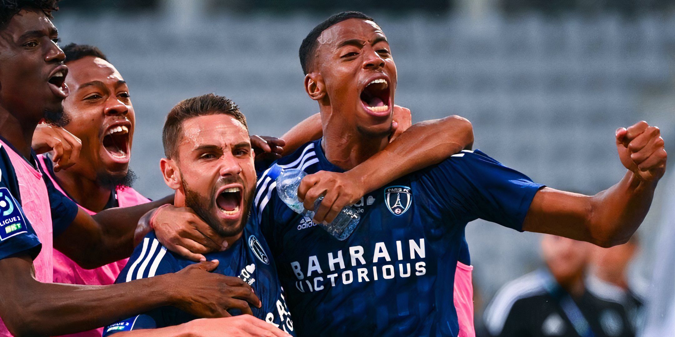 Paris FC Players celebrate in their home jersey